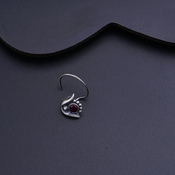 a close up of a pair of earrings on a table