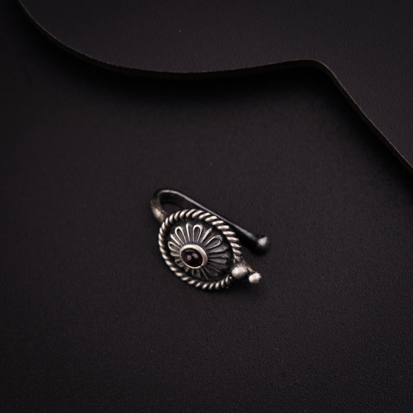 a close up of a metal object on a black surface