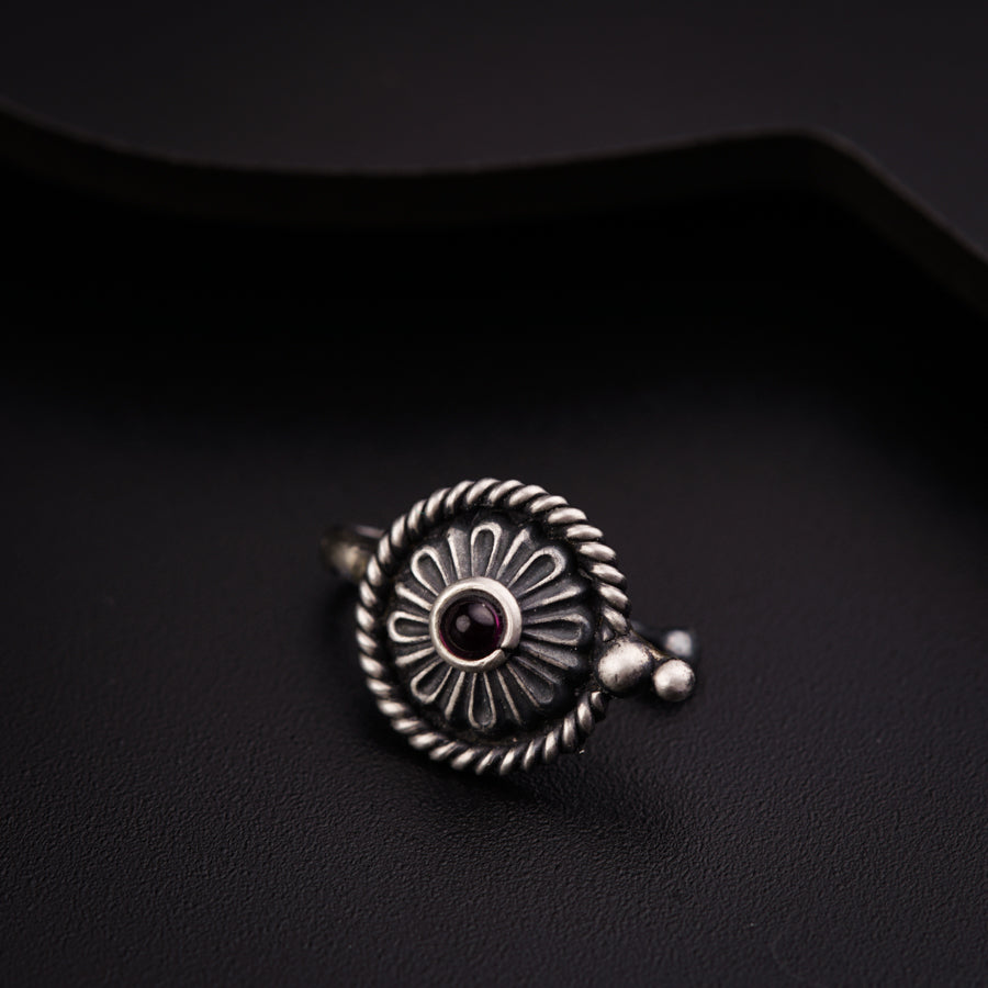 a close up of a ring on a black surface