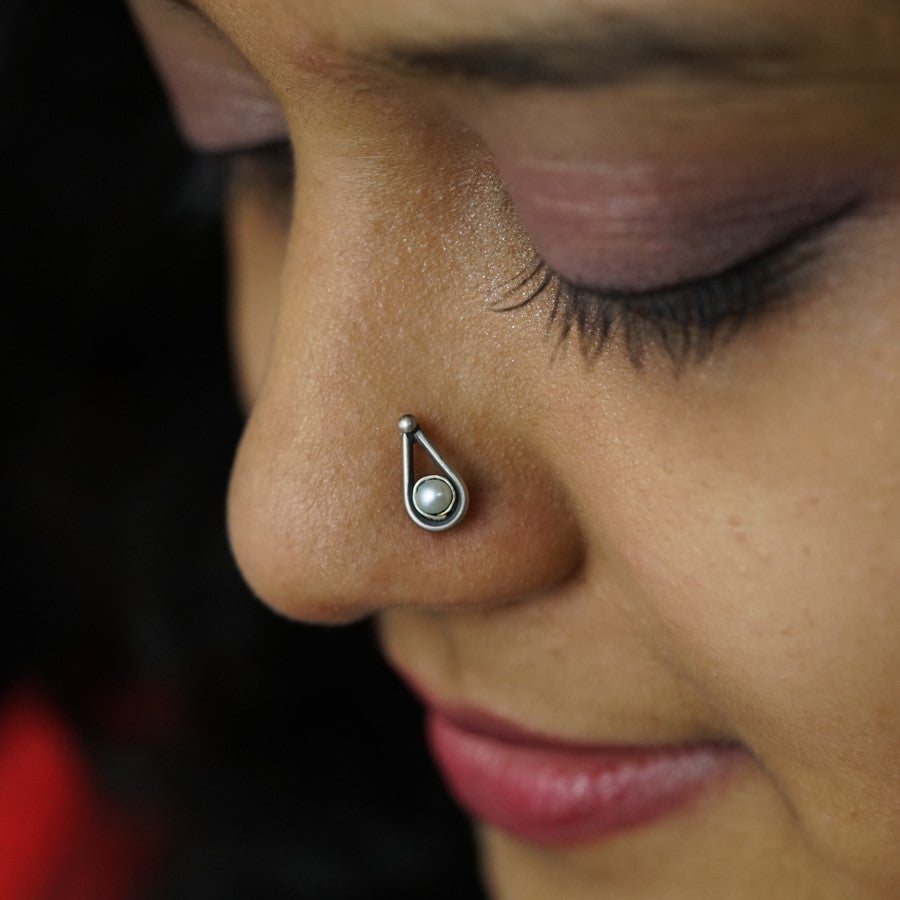 a close up of a person with a nose piercing