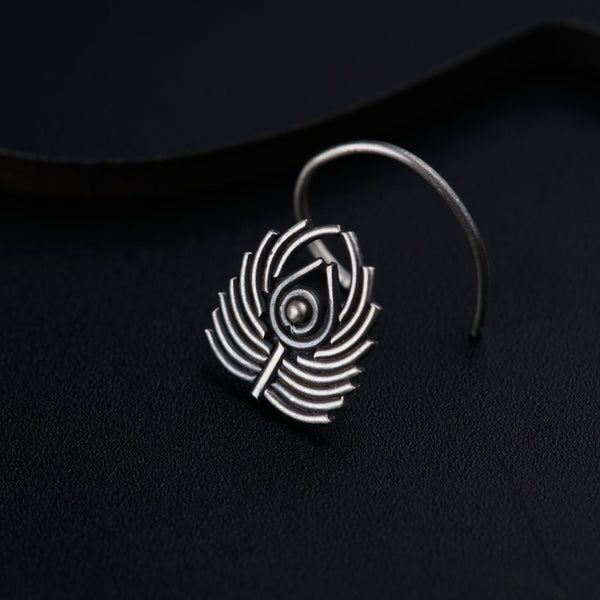 a close up of a pair of earrings on a black surface