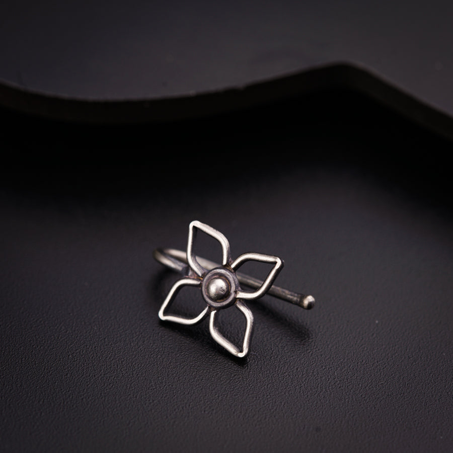 a silver ring with a flower on it