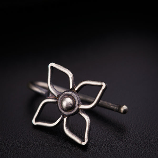 a silver ring with a flower on it