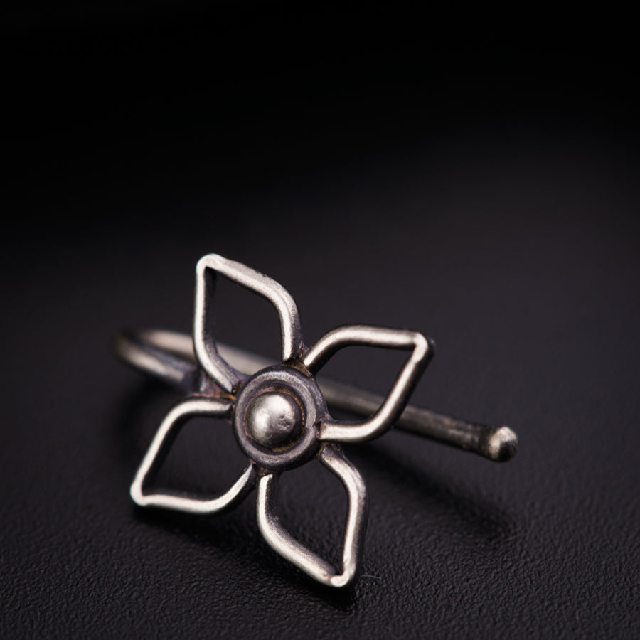 a silver ring with a flower on it