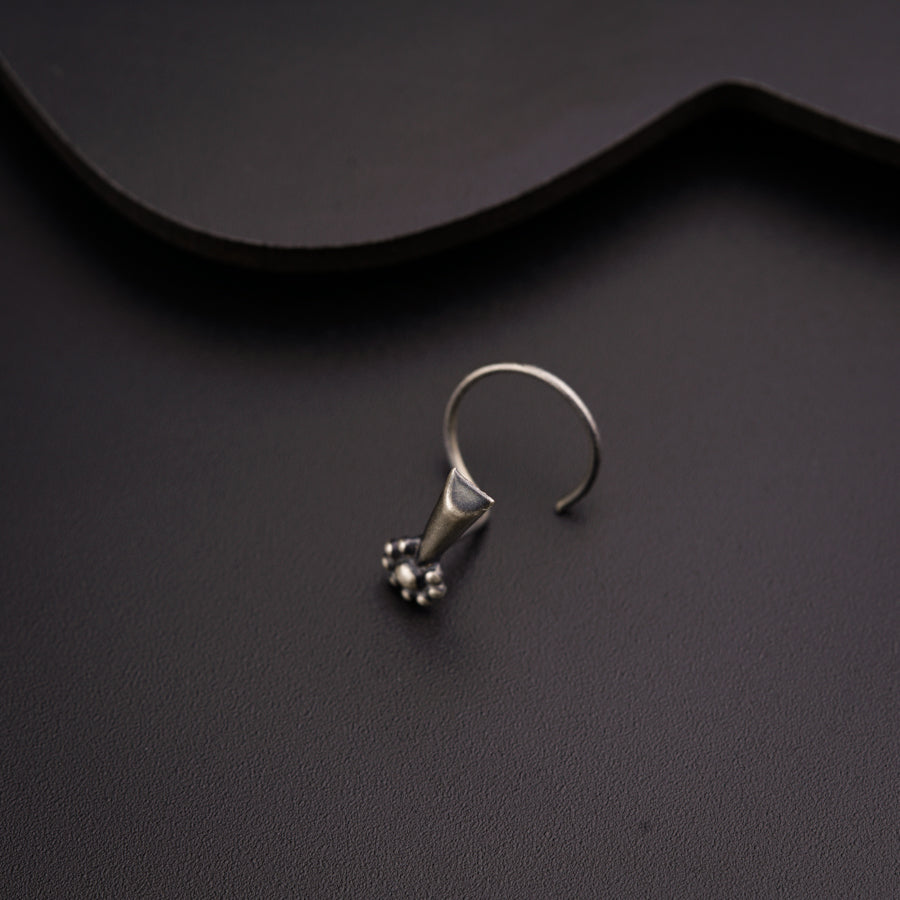 a pair of silver rings sitting on top of a table