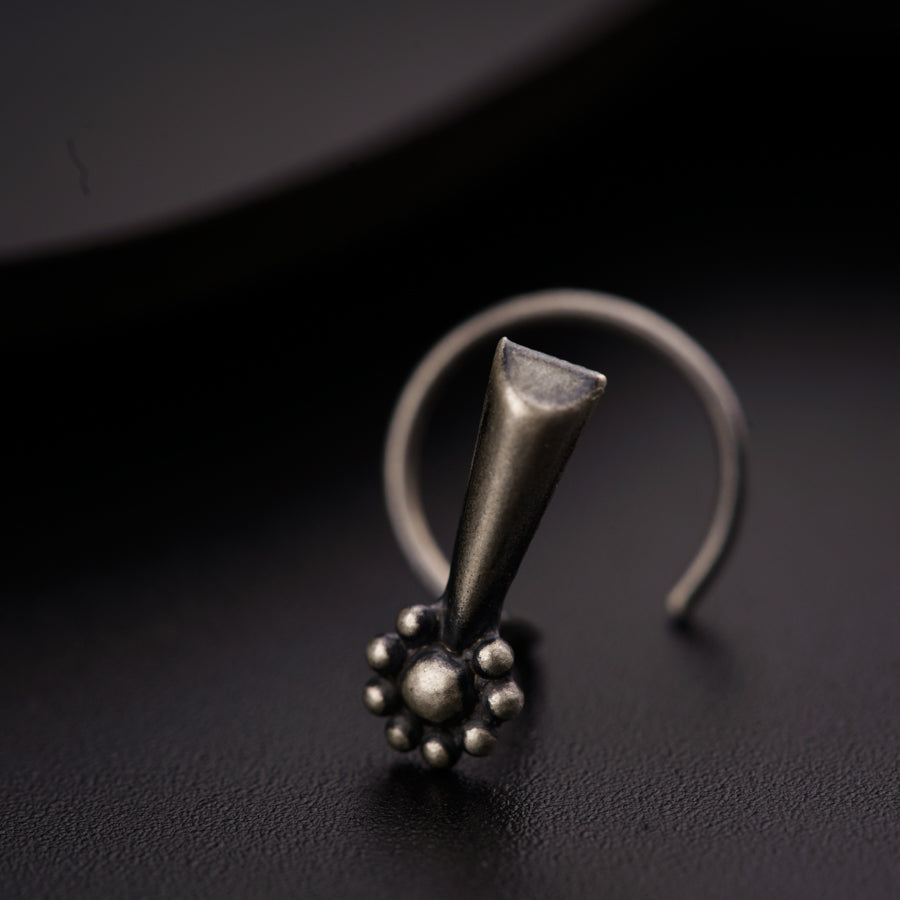 a silver ring with a ball on top of it