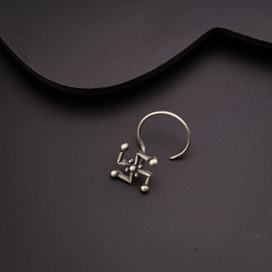 a pair of earrings sitting on top of a table