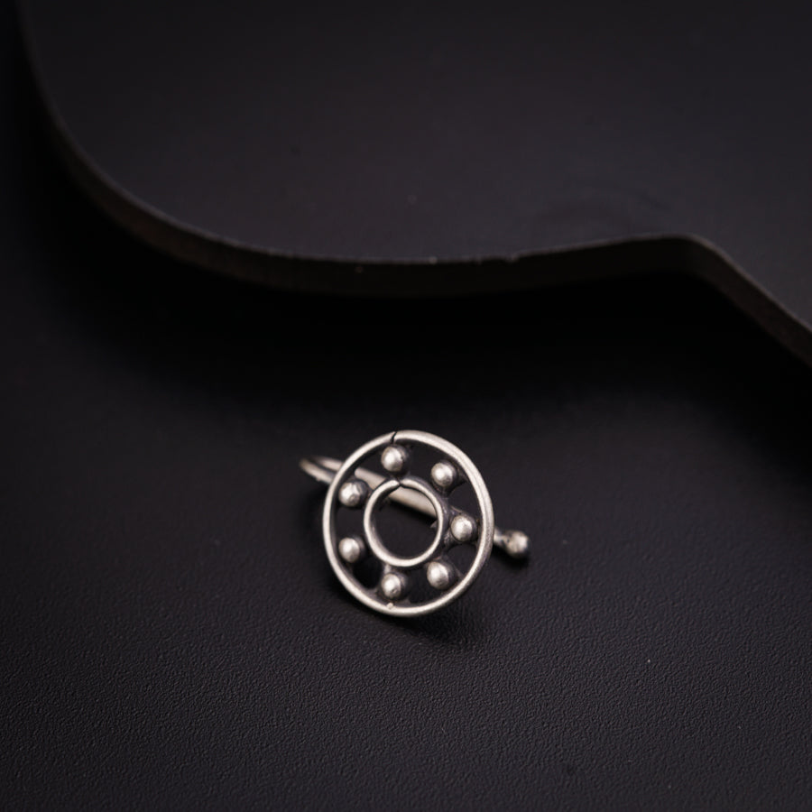 a close up of a metal object on a black surface
