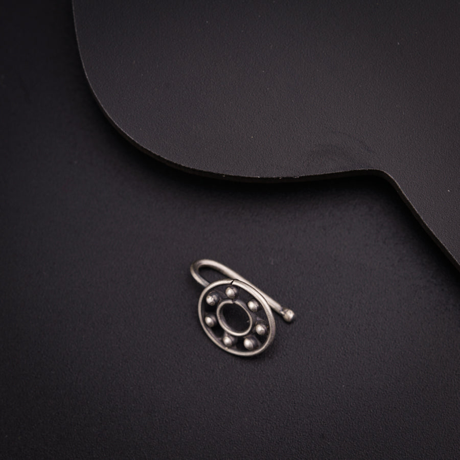 a close up of a metal object on a black surface
