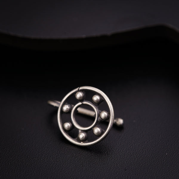 a close up of a metal object on a black surface