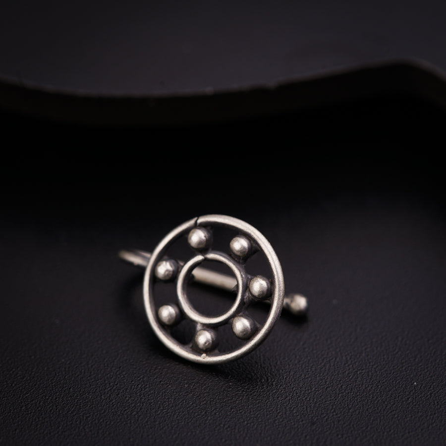 a close up of a metal object on a black surface