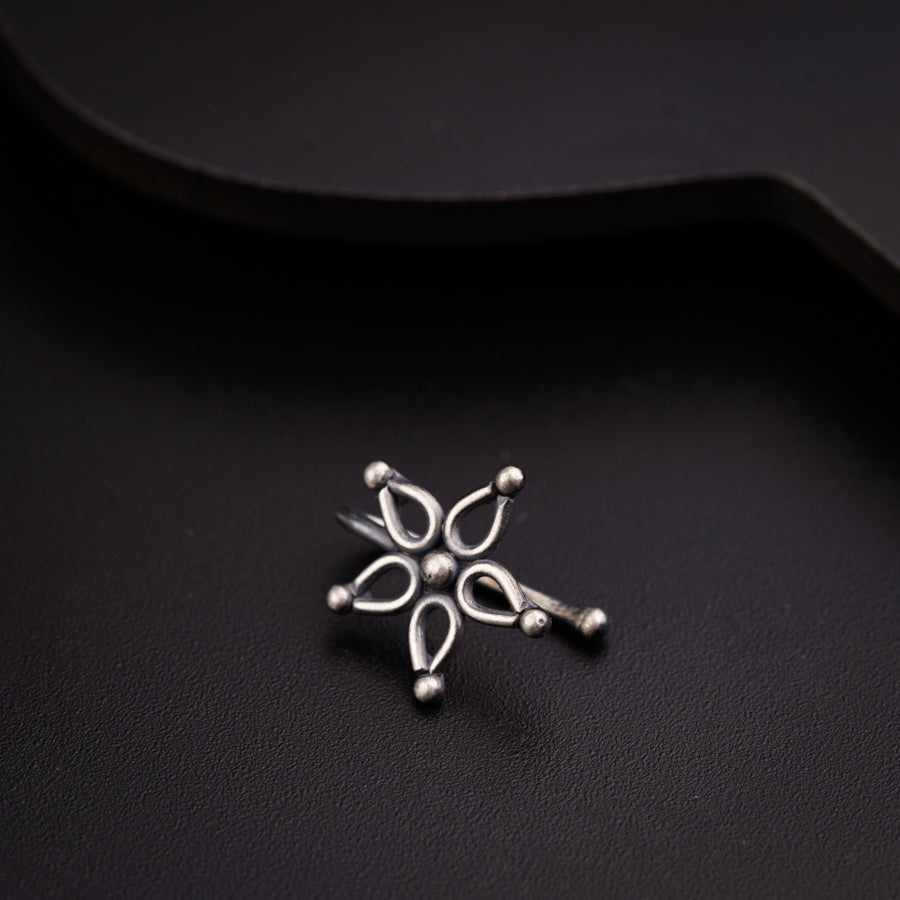 a close up of a metal object on a black surface