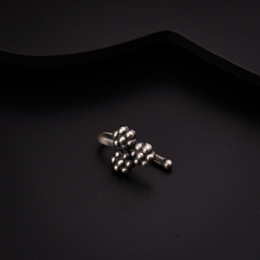 a silver ring sitting on top of a black surface