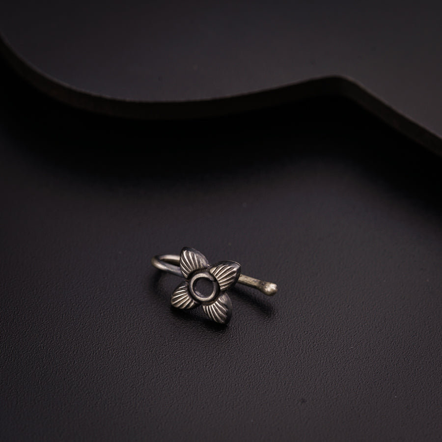 a close up of a metal object on a black surface