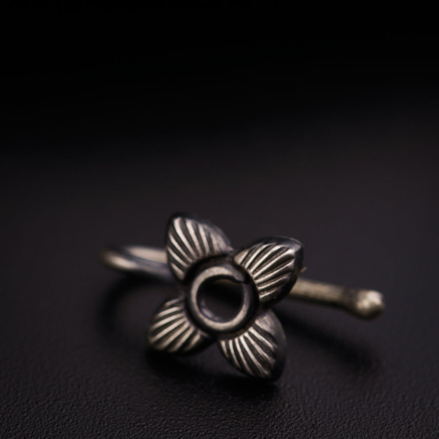 a silver ring with a flower on it