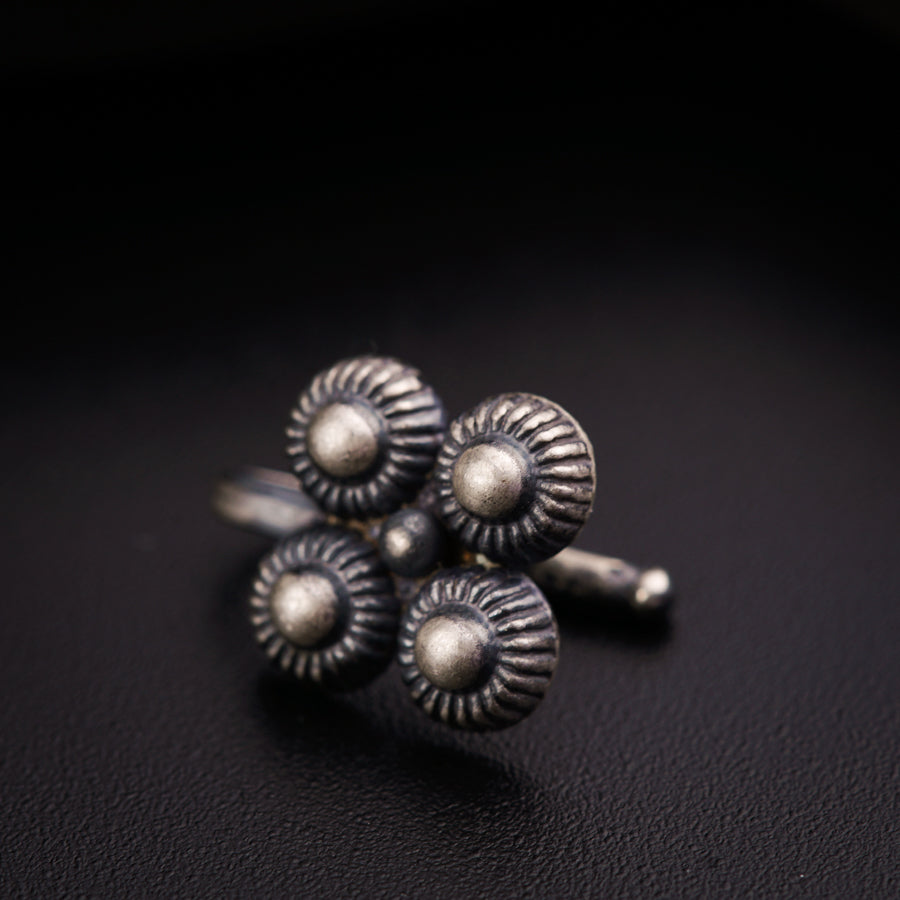 a close up of three silver rings on a black surface