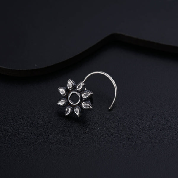 a close up of a pair of earrings on a black surface