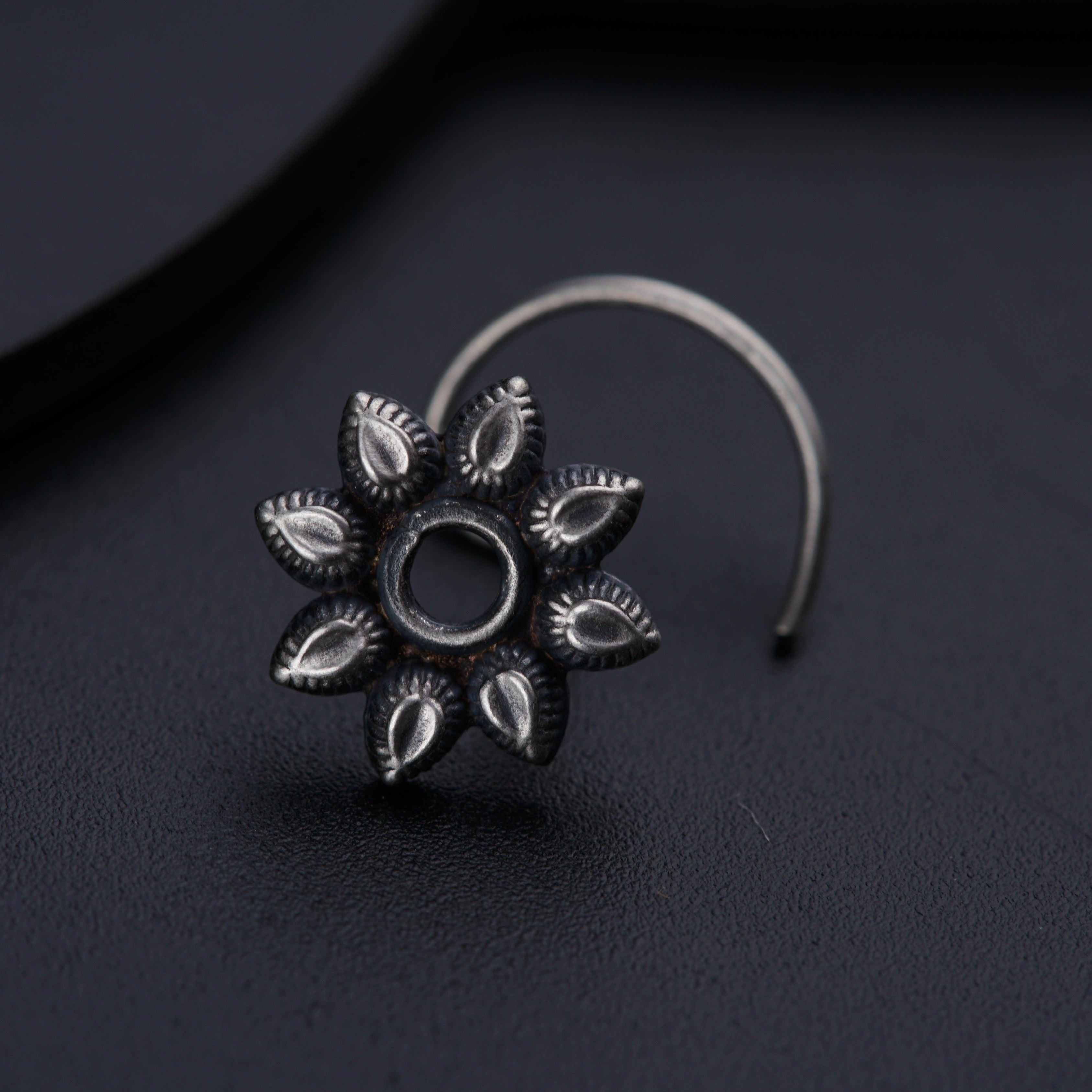 a close up of a ring on a black surface