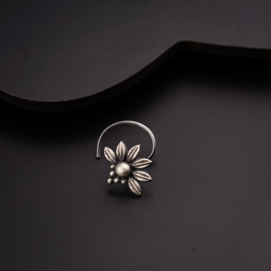 a close up of a ring with a flower on it