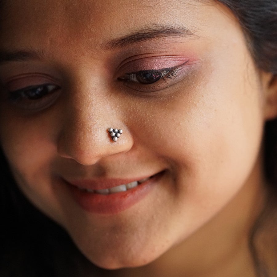 a close up of a woman with a nose piercing