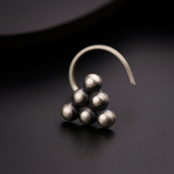 a close up of a pair of earrings on a black surface