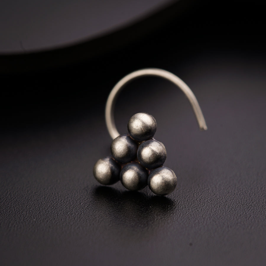 a close up of a pair of earrings on a black surface