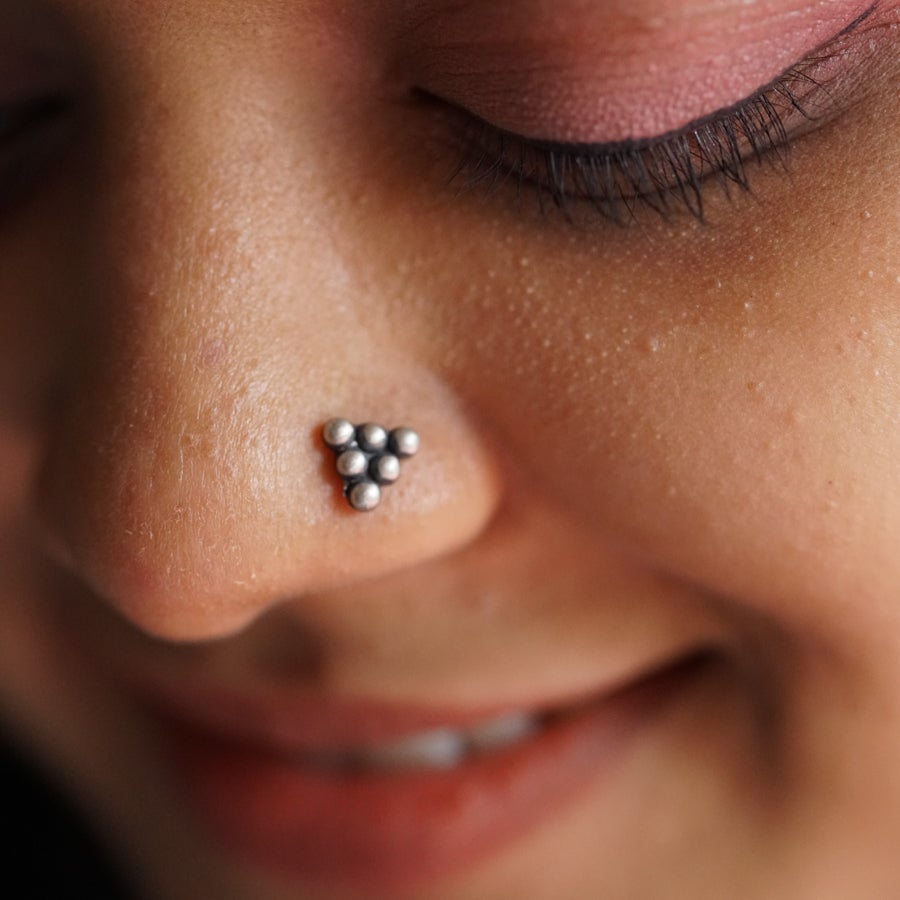 a close up of a person with a nose piercing