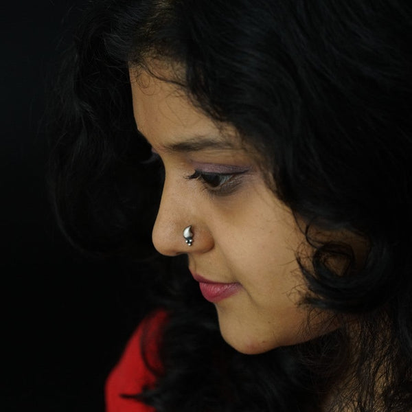 a close up of a woman with a nose ring