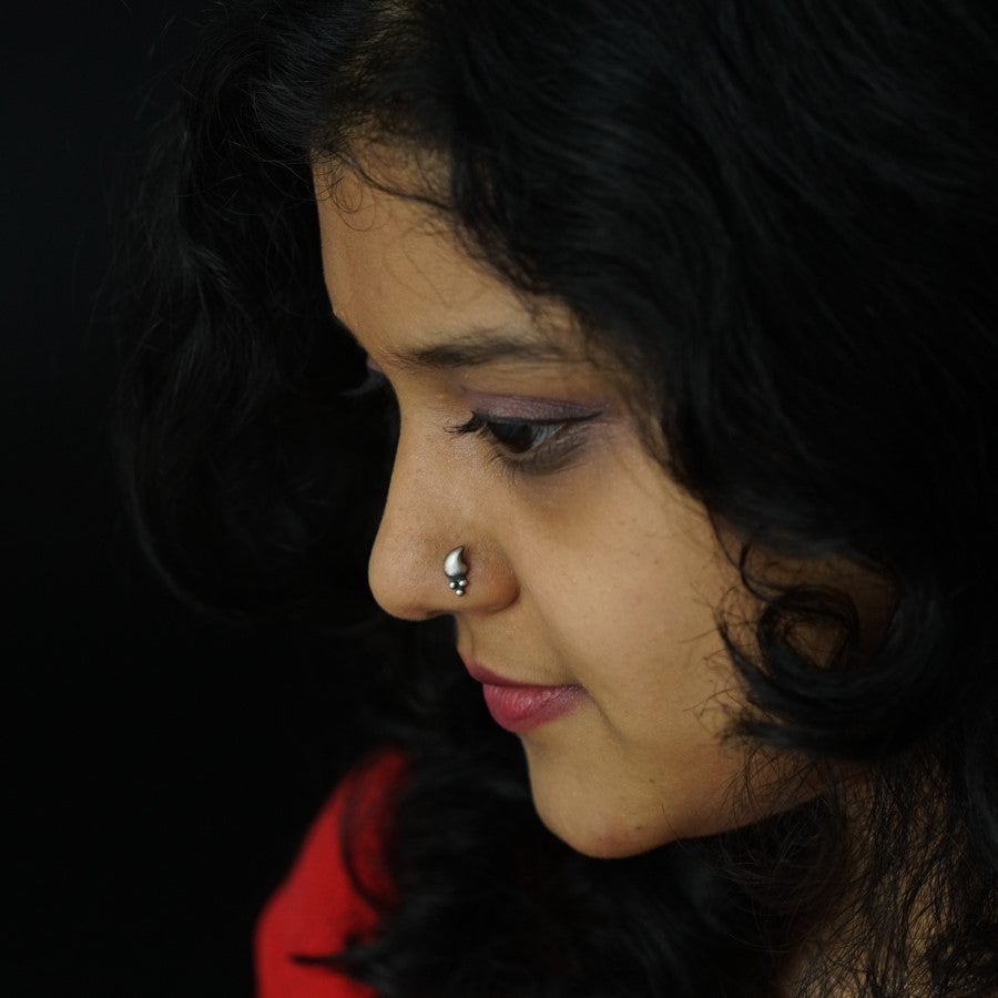 a close up of a woman with a nose ring