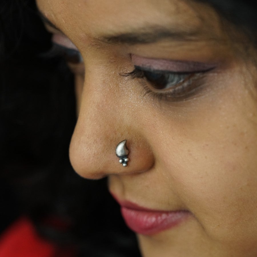 a close up of a woman with a nose piercing