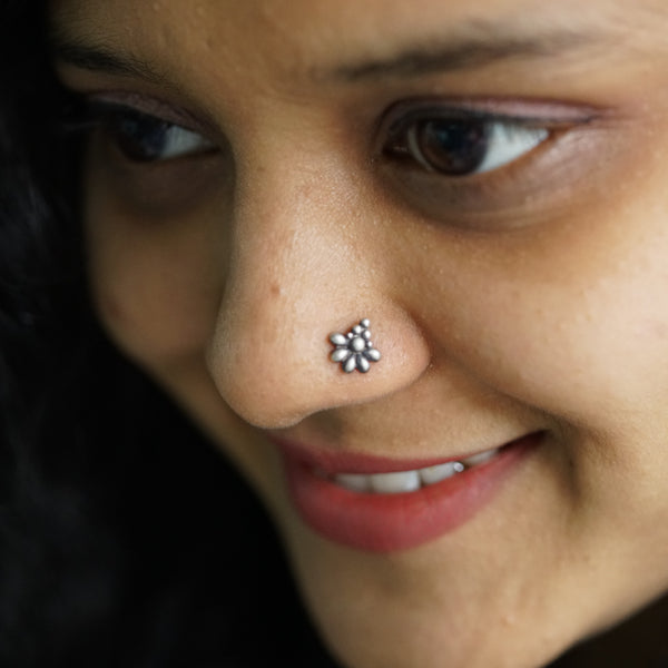 a close up of a person with a nose piercing