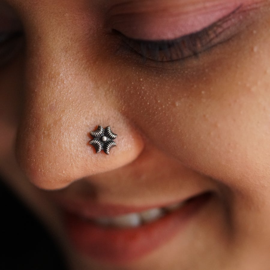 a close up of a person with a nose piercing