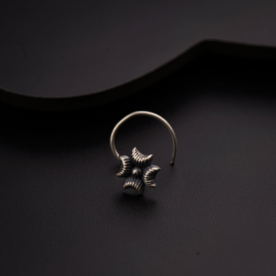 a pair of silver rings sitting on top of a black surface