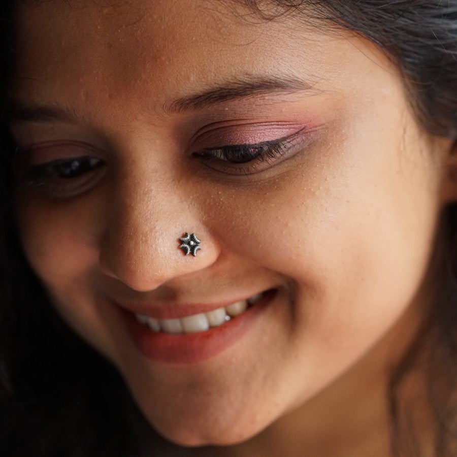 a close up of a woman with a nose piercing