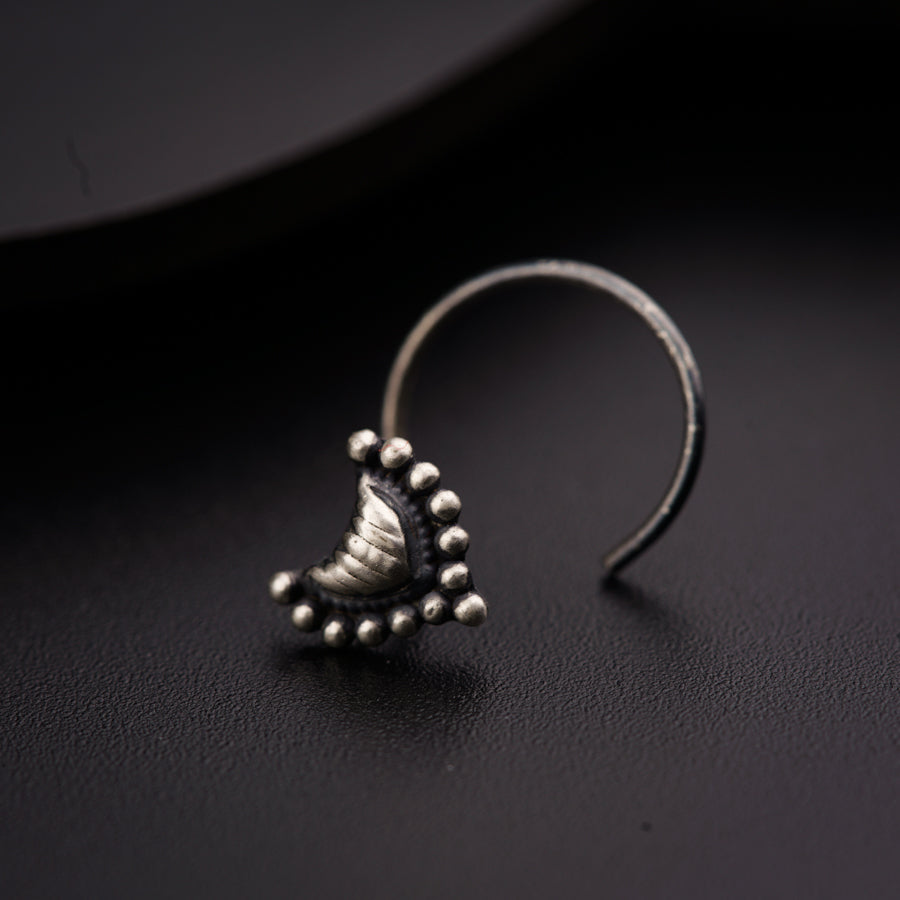 a close up of a pair of earrings on a black surface