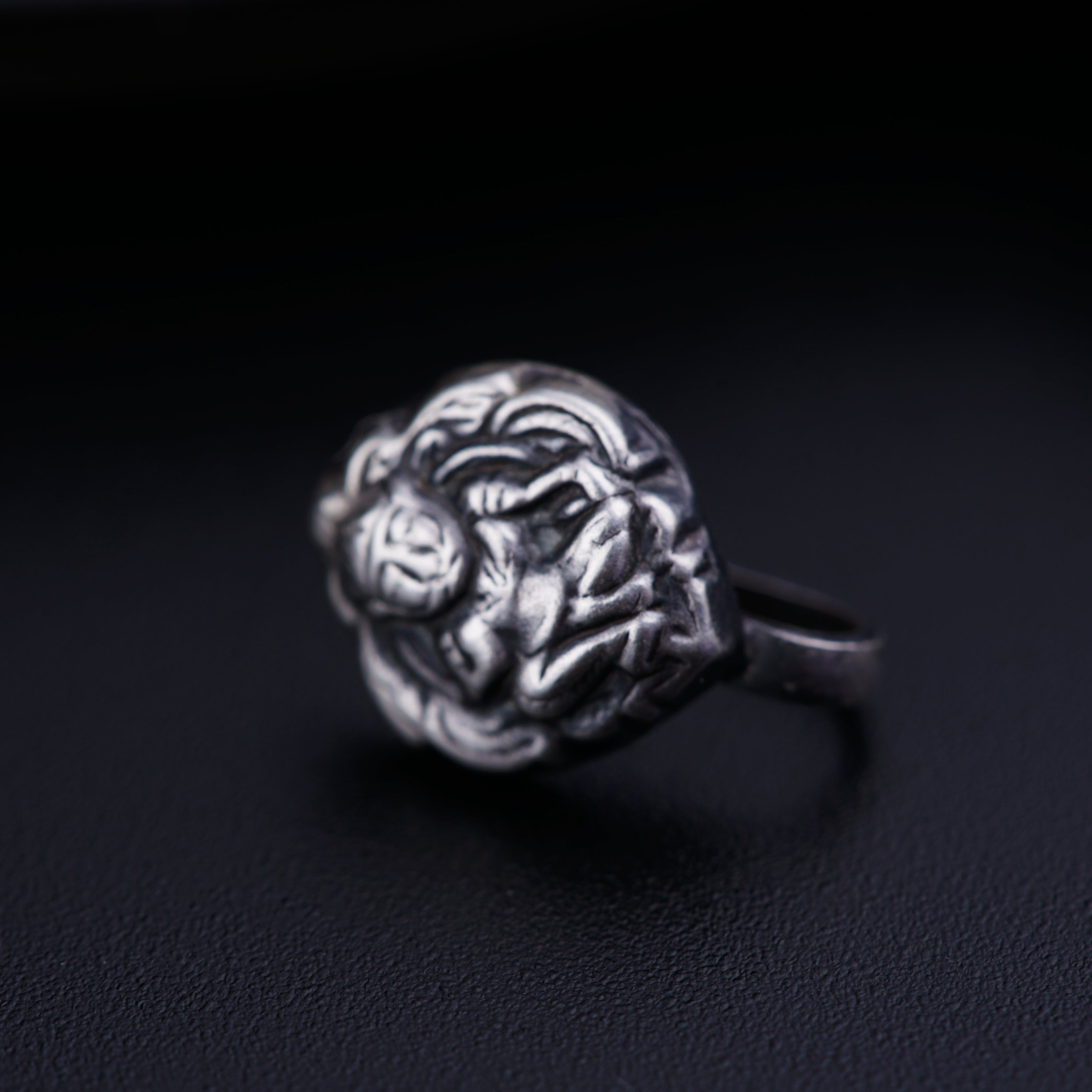 a close up of a ring on a black surface