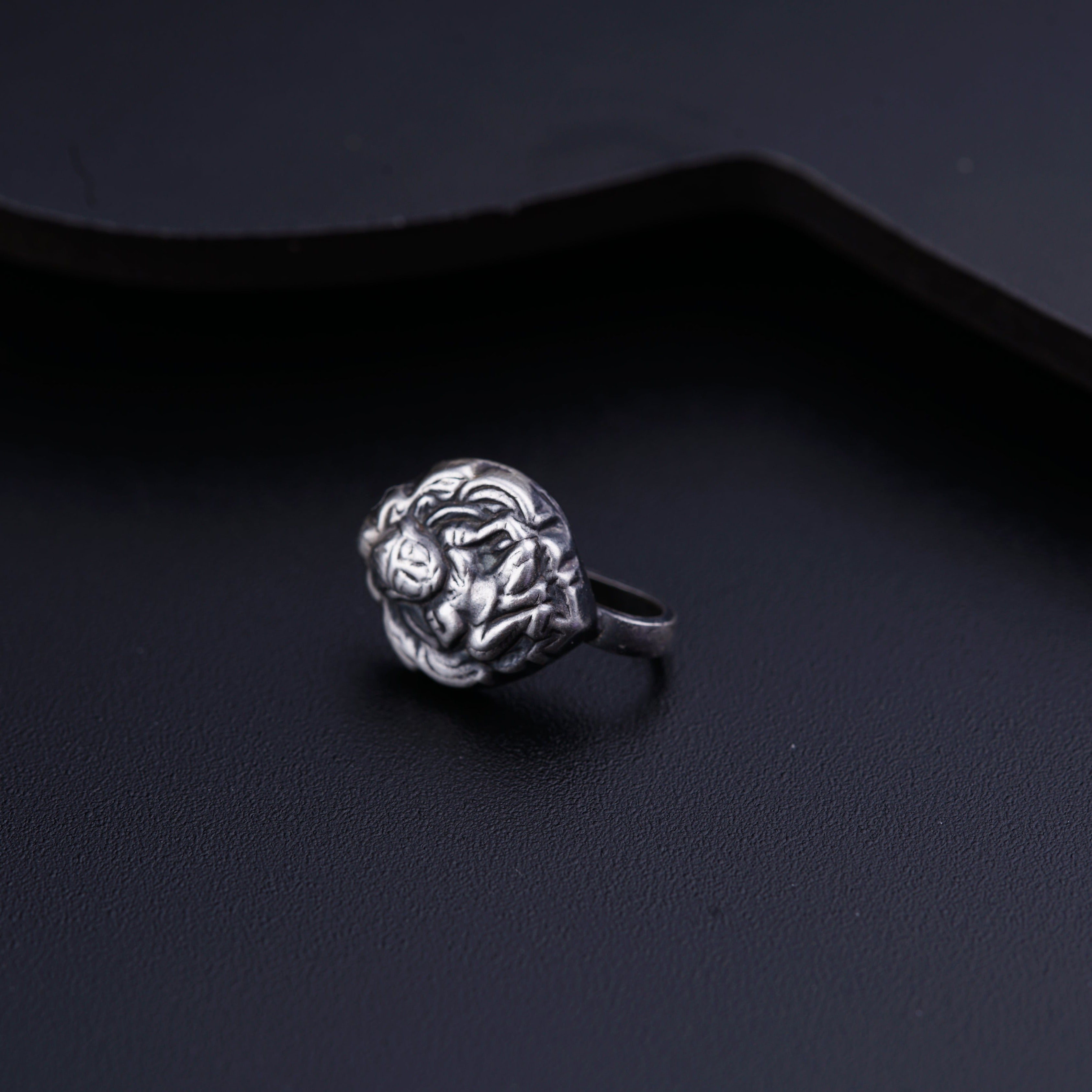a close up of a ring on a black surface
