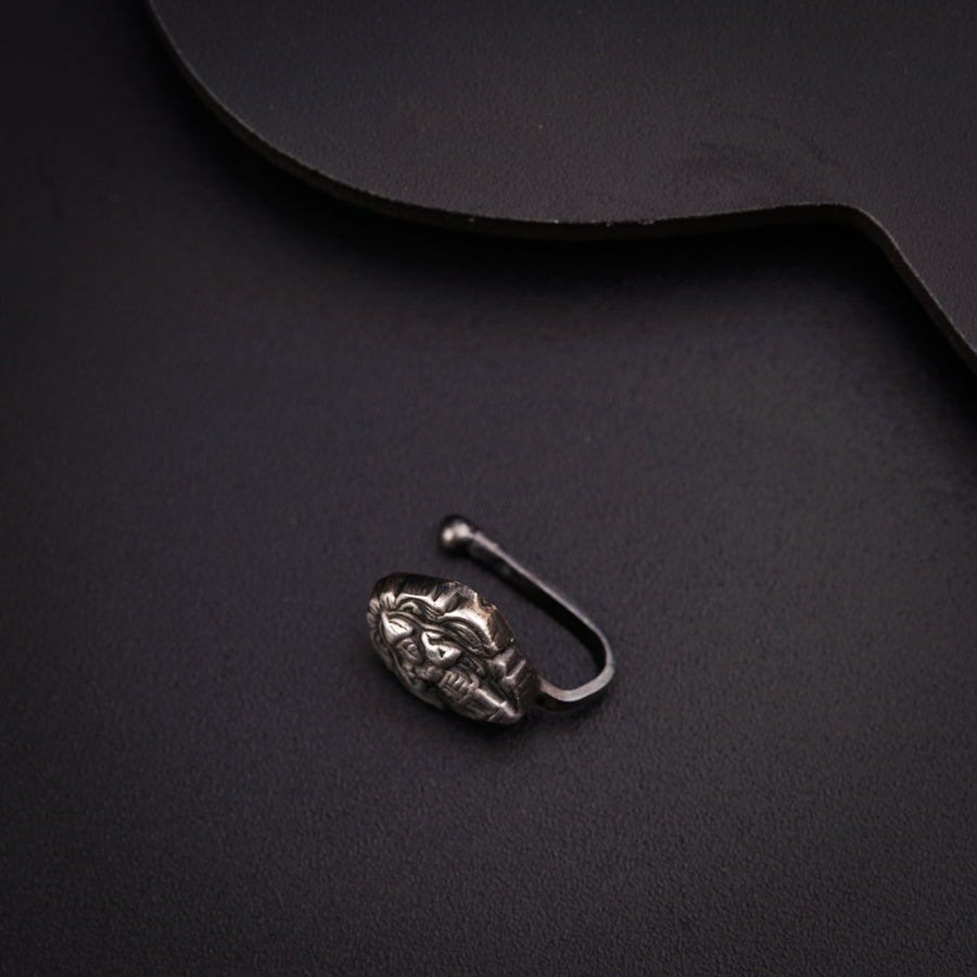 a metal hook with a face on it