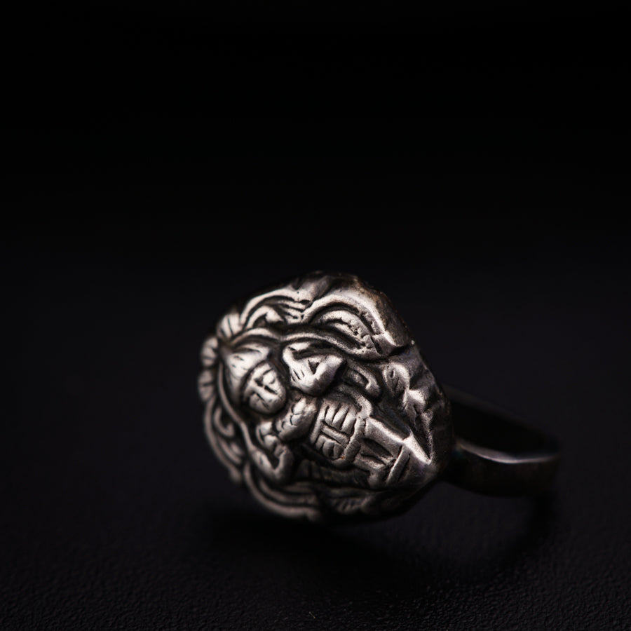 a silver ring with a lion head on it