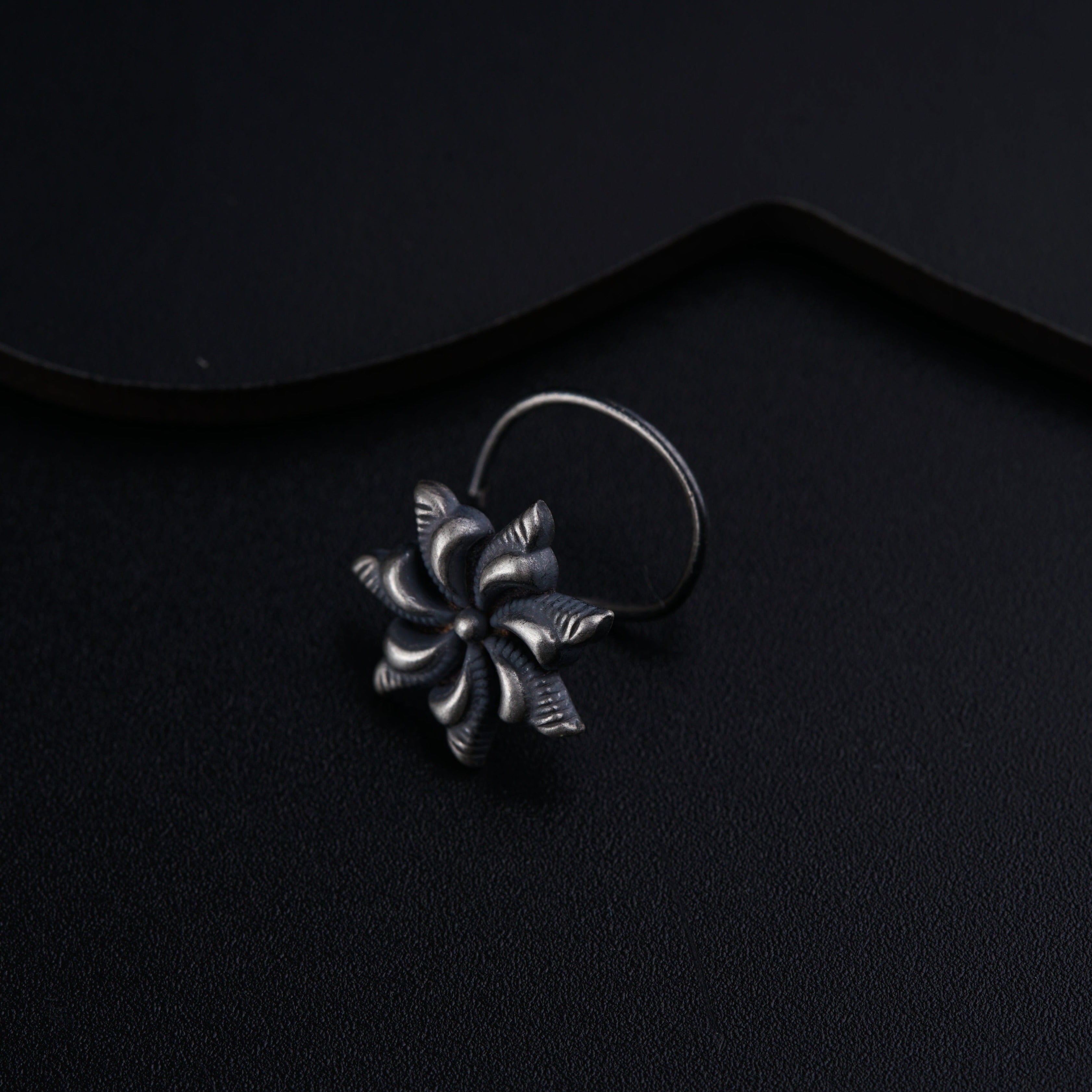 a close up of a ring on a black surface