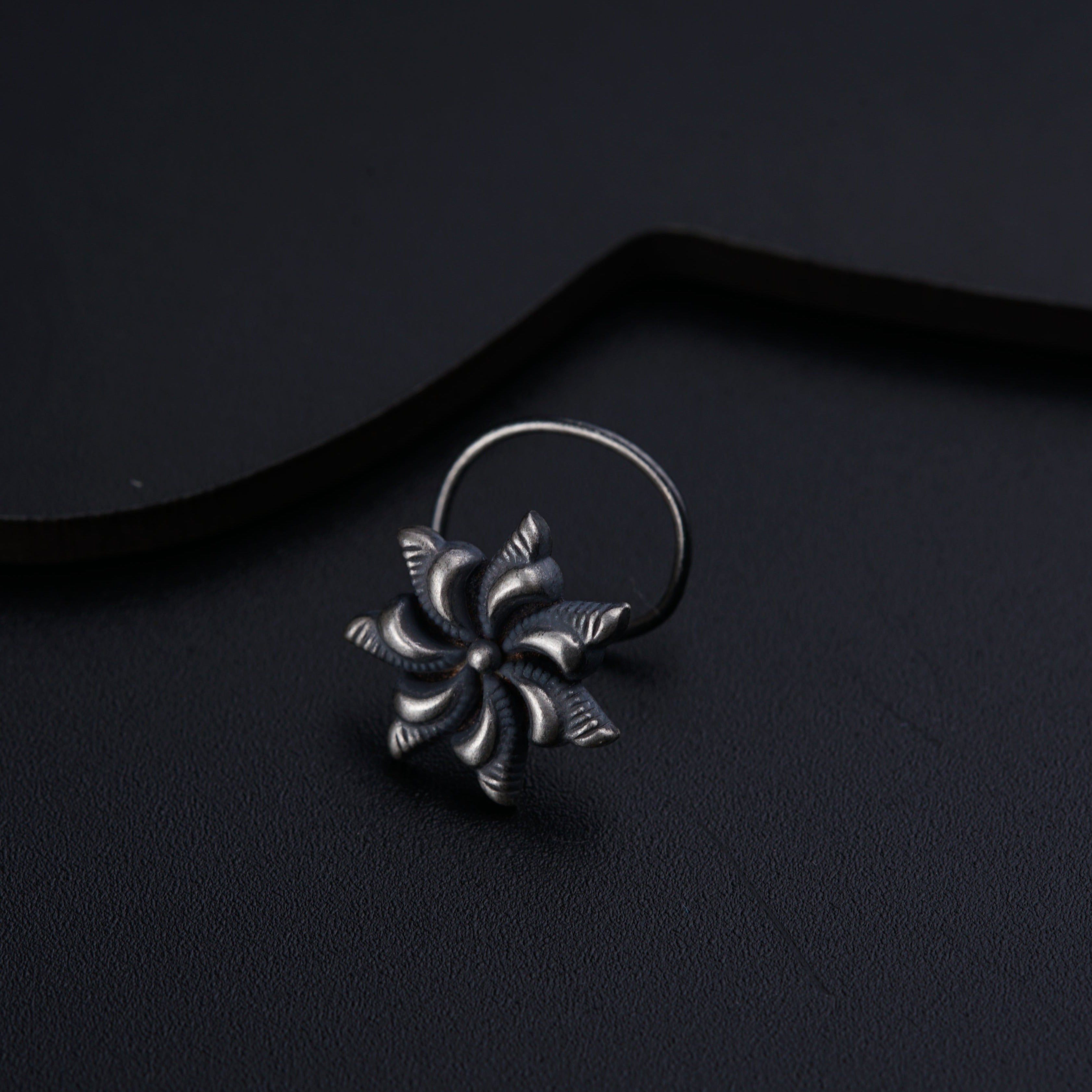 a close up of a ring on a black surface