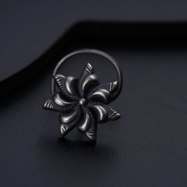 a silver ring with a flower design on it