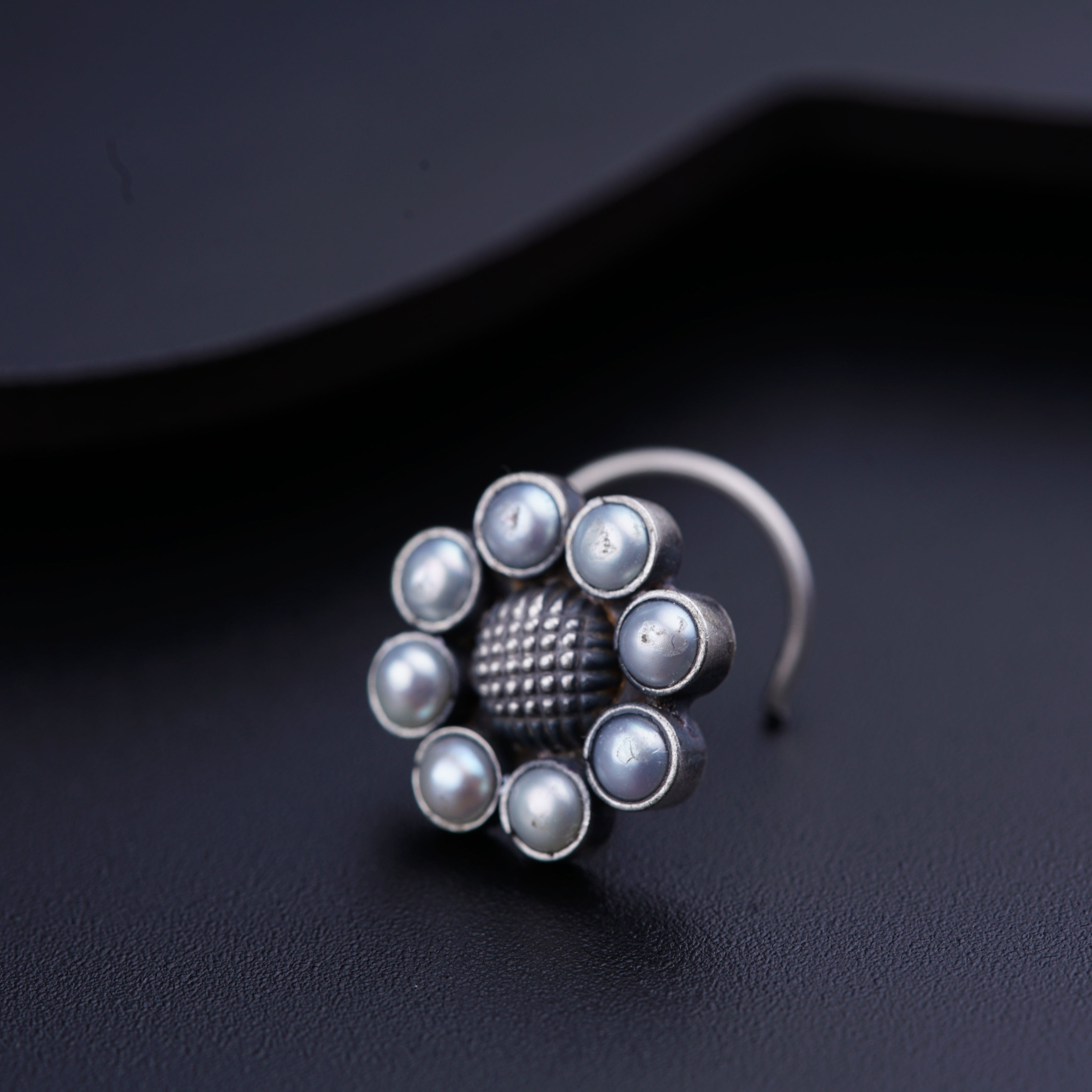 a close up of a ring on a black surface