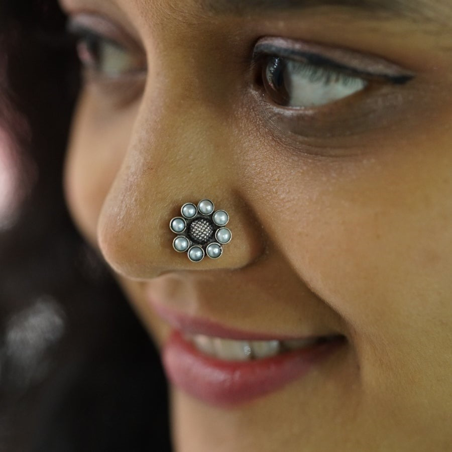 a close up of a person with a nose piercing