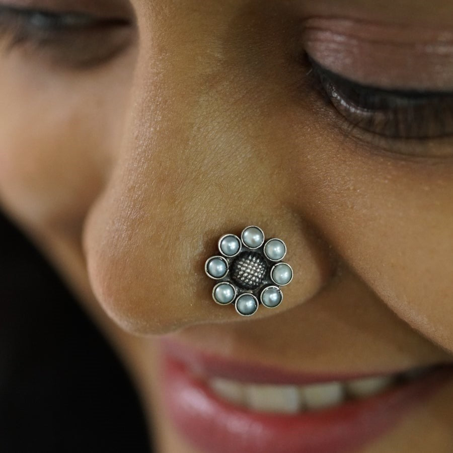 a close up of a person with a nose piercing