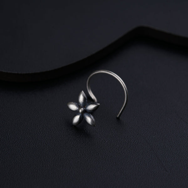 a close up of a pair of earrings on a black surface