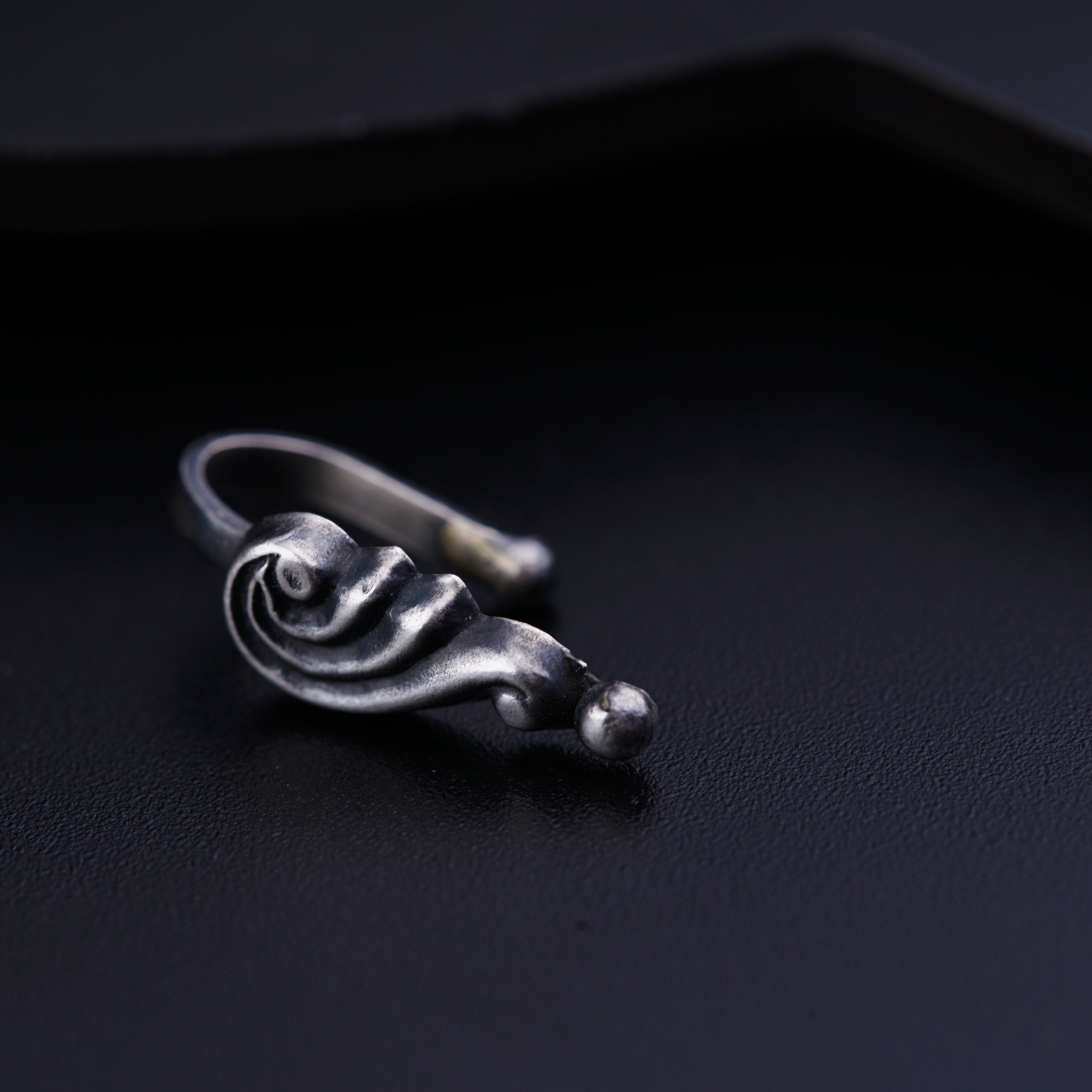 a close up of a ring on a black surface