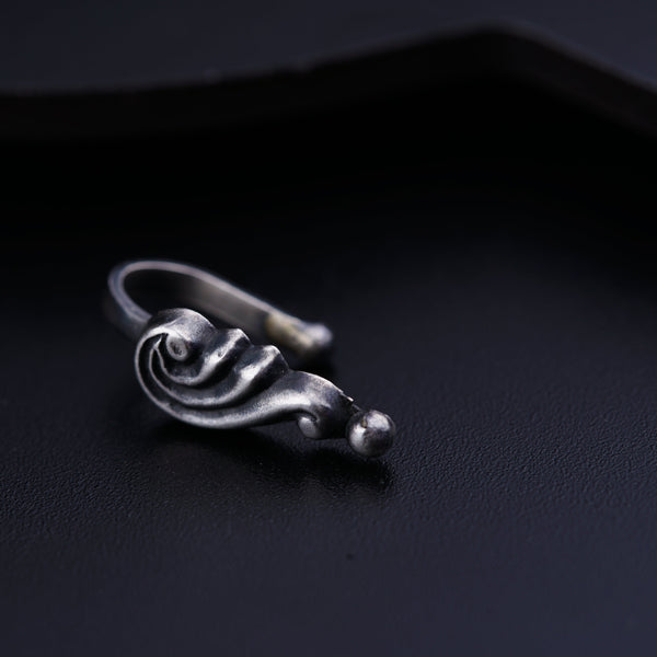 a close up of a ring on a black surface