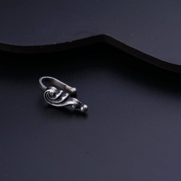 a close up of a metal object on a black surface