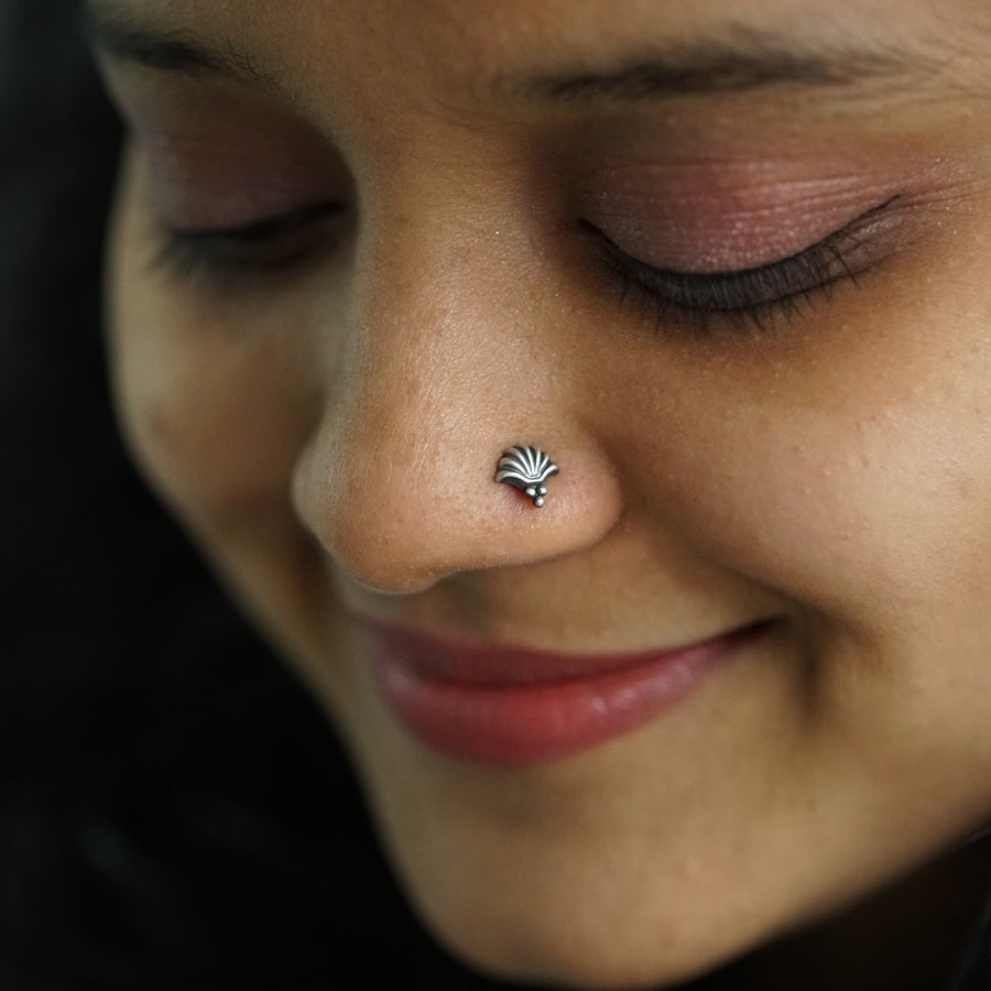 a close up of a person with a nose piercing